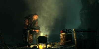 man cooking on a camp fire